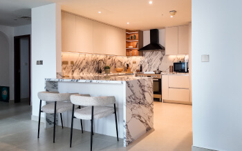 Open-Concept Marble Waterfall Kitchen